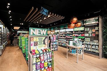 Interior of Holland & Barrett store, featuring a promotional shelf of new food products